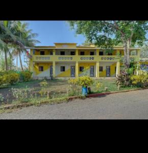 a yellow building with words on the side of it at Yellow House in Zirad