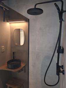 a bathroom with a shower with a sink and a mirror at Vakantiehuis 6 personen-rustig en karaktervol in Geraardsbergen +5 photos