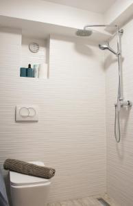 a white bathroom with a shower and a toilet at Secluded Studio in Central Sesvete in Sesvete