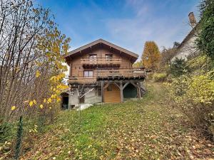 a large wooden house on top of a hill at Chalet en bois avec très belle vue sur la montagne in Colmars