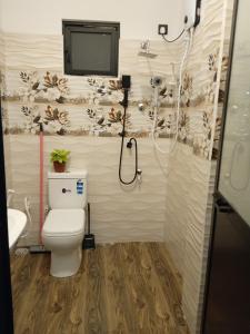 a bathroom with a shower and a toilet and a sink at Free Breeze Guest & Villa in Weligama