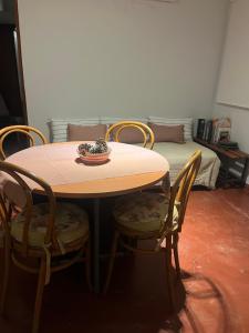 a table with four chairs and a bowl on top at Villa Paula in Ranchos