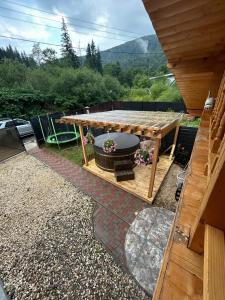 a picnic table in a backyard with a view at Cabana EviMat Azuga in Azuga