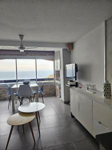a kitchen with a table and chairs and a television at Portvendres Sea view in Port-Vendres