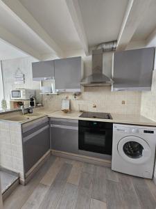a kitchen with a washer and a dishwasher at Portvendres Sea view in Port-Vendres +4 photos