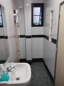 a bathroom with a sink and a window and a shower at Krabi Rooms - Appartment 4 in Krabi town
