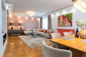 a living room with a couch and a table at Vienna Deluxe Residences - Schönbrunn in Vienna