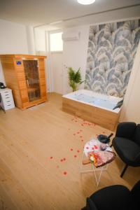 a room with a tub with red petals on the floor at Attimo d'amore in Quinto Vicentino