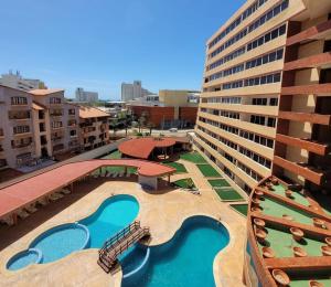 an overhead view of a resort with two pools at Apartamento Costa Azul Oasis frente CC La Vela in Porlamar