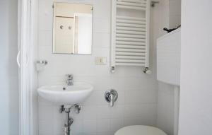 a white bathroom with a sink and a toilet at Galletto del Chianti in Panzano +6 photos