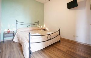 a bedroom with a large bed and a wooden floor at Galletto del Chianti in Panzano