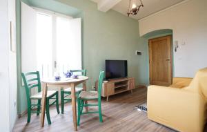 a living room with a table and chairs and a television at Galletto del Chianti in Panzano