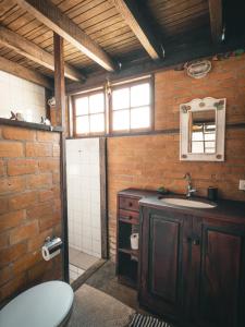 a bathroom with a sink and a toilet in it at Casa Pindorama - Chalé Opy in Paraty +23 photos