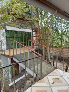 a staircase leading up to a building with trees at Kio Farm2 in Kiserian