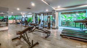 a gym with several exercise equipment in a room at 41 квадратный метр, апартамент на пляже Сурин in Surin Beach