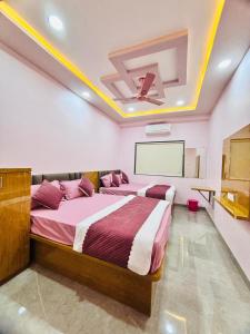 a bedroom with a large bed and a projection screen at Sairam Residency in Ellora