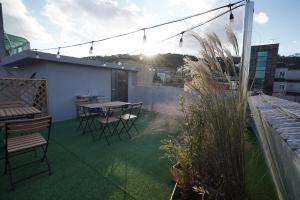 a patio with a table and chairs on a balcony at stay105행궁 in Suwon