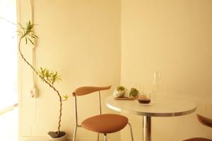 a small table and a chair in a room at stay105행궁 in Suwon