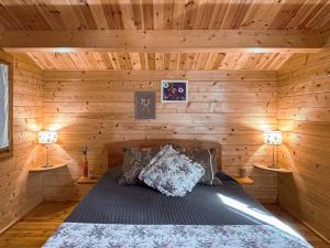 a bedroom with a bed in a wooden cabin at Chale dos Sobreiros in Bicas +29 photos