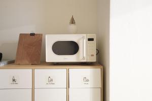 a microwave sitting on top of a cabinet at stay105행궁 in Suwon