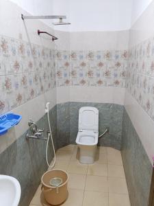 a bathroom with a toilet and a sink at De Dreams beach in Puducherry