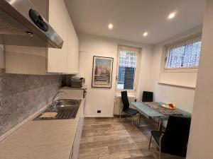a kitchen with a table and a sink and a table and a dining room at SalitaCentrale6 in Bellagio
