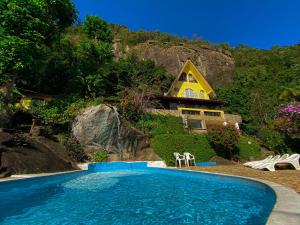 a house on a hill with a swimming pool at Pousada Chale da Montanha in Petrópolis +74 photos