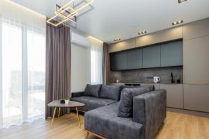 a living room with a couch and a table at Baltic Harmony Apartments in Palanga