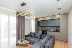 a living room with a couch and a table at Baltic Harmony Apartments in Palanga