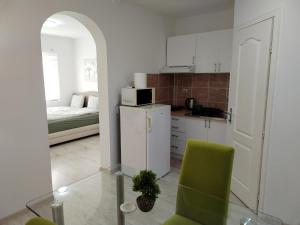 a small kitchen with a green chair in a room at Andrijana in Soko Banja