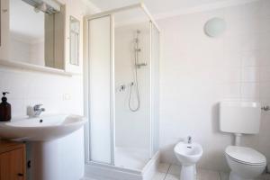 a bathroom with a shower and a toilet and a sink at Stars Apartments Gressan in Cerise +28 photos