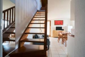 a staircase in a living room with a dining room at Stars Apartments Gressan in Cerise