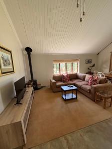 a living room with a couch and a tv at Westview Estate in Shawlands +8 photos