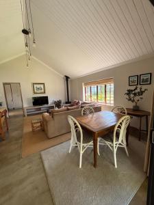 a living room with a wooden table and chairs at Westview Estate in Shawlands