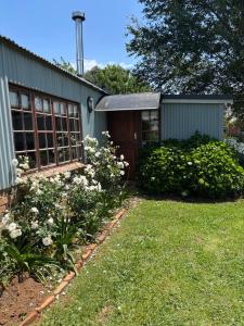 a garden with a house with a garage at Westview Estate in Shawlands