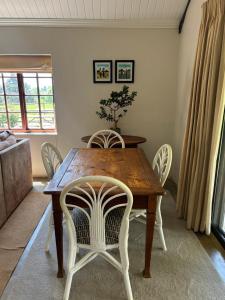 a dining room with a wooden table and chairs at Westview Estate in Shawlands