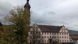 a large building with a clock tower in front of it at Klosterblick in Gengenbach