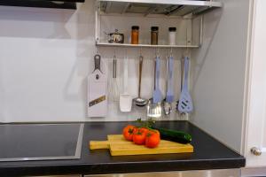 a kitchen counter with vegetables on a cutting board and utensils at Zum Friedl in Wackersberg