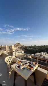 a table with plates of food on a balcony at Negmet Siwa Hotel in Siwa