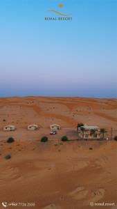 a group of cars parked in the desert at Remal Chalet in Bidiyah +5 photos