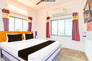 Ένα ή περισσότερα κρεβάτια σε δωμάτιο στο Hotel O Green Palace