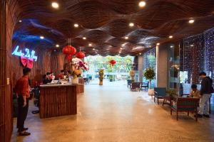a restaurant with people sitting at tables and a bar at Avatar Danang Hotel in Da Nang +53 photos