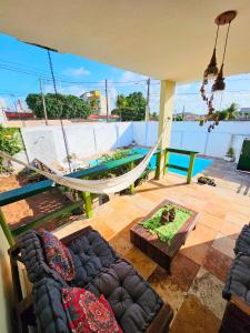 a living room with a hammock and a couch at Hostel La Casa de Mabel in Natal