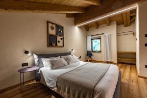 ein Schlafzimmer mit großem Bett und Holzboden in der Unterkunft Lo Paglier - Le Four des Alpes in Rhemes-Saint-Georges