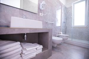 a bathroom with a sink and a toilet at Donnosanto Residence Pantanagianni in Torre Santa Sabina +17 photos