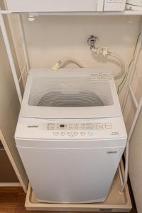 a washing machine is sitting in a shelf at sakura 201 in Tokyo