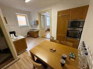 a living room with a table and a kitchen at Centrum Brezno in Brezno