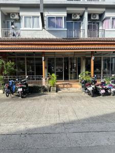 eine Gruppe von Motorrädern, die vor einem Gebäude geparkt sind in der Unterkunft Baan KetKaew GuestHouse 1 in Patong Beach