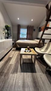 a bedroom with a bed and a table in a room at Sleep with the stars in Oslo