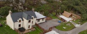 an aerial view of a large white house at The Captains Achmelvich in Lochinver +22 photos